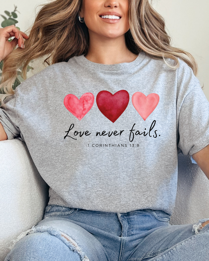 Love Never Fails Pink Heart Valentine Sweatshirt – 1 Corinthians 13:8 Faith Crewneck