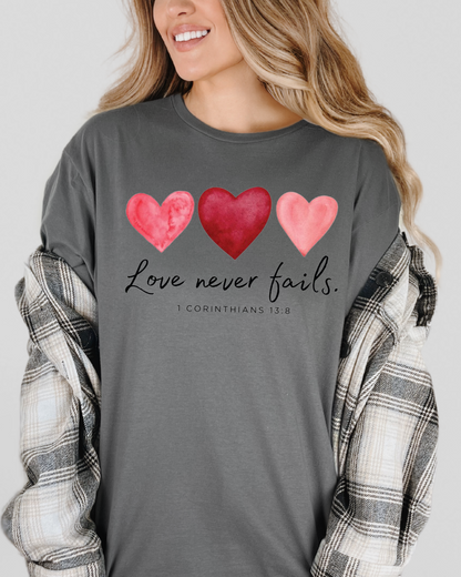 Love Never Fails Pink Heart Valentine Sweatshirt – 1 Corinthians 13:8 Faith Crewneck