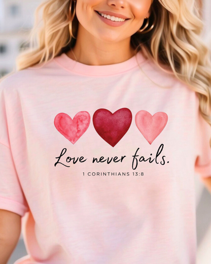 Love Never Fails Pink Heart Valentine Sweatshirt – 1 Corinthians 13:8 Faith Crewneck